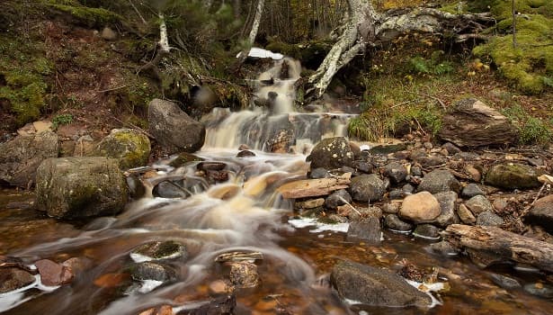 A waterfall flowing through the woods near Marquette